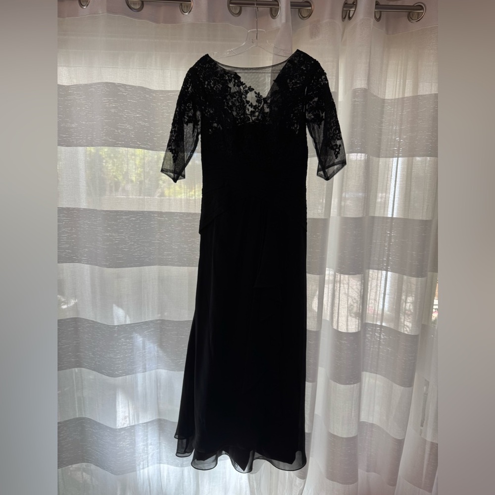 Formal 3/4 length lace sleeve black dress with beautiful details. Floor length.
